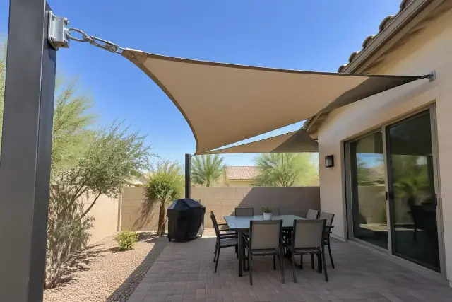 10x20 shade sail over a residential patio in Gilbert, AZ, showing tensioned fabric and corner hardware.