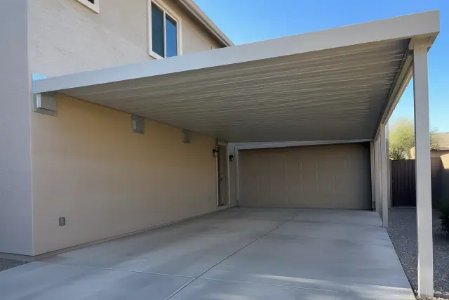 Attached carport installed on a stucco exterior wall above a concrete driveway in Gilbert, AZ.