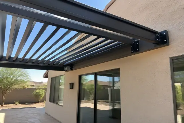 Attached pergola installation with a louvered roof and travertine patio in Gilbert, AZ.
