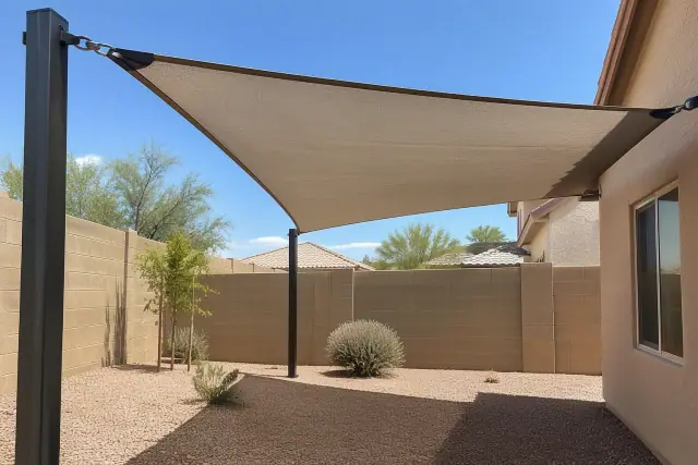Breathable HDPE shade cloth tensioned on steel anchors at a home in Gilbert, AZ.