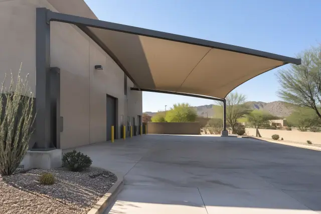 Cantilever shade structure with a fabric canopy over a concrete loading zone in Fountain Hills, AZ.