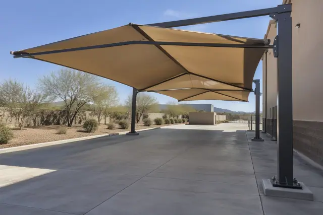 Cantilever shade structure with steel frame and fabric canopy over a concrete loading zone in San Tan Valley, AZ.