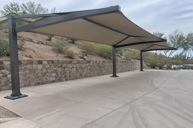 Cantilever shade structure with steel frame and fabric canopy over a concrete loading zone in Paradise Valley, AZ.