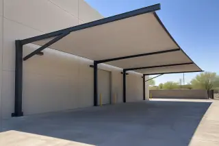Offset steel frame and fabric canopy over a concrete loading zone in Gilbert, AZ.