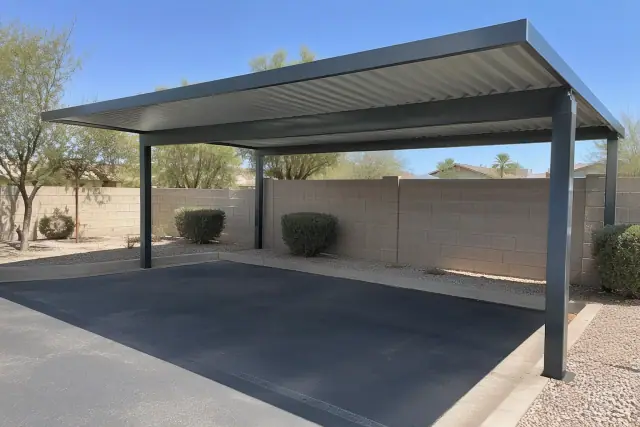 Carport installation with secured corrugated metal roof panels over a paved parking bay in Chandler, AZ.