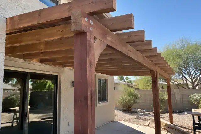 Cedar and redwood patio cover installation in a Gilbert, AZ backyard.