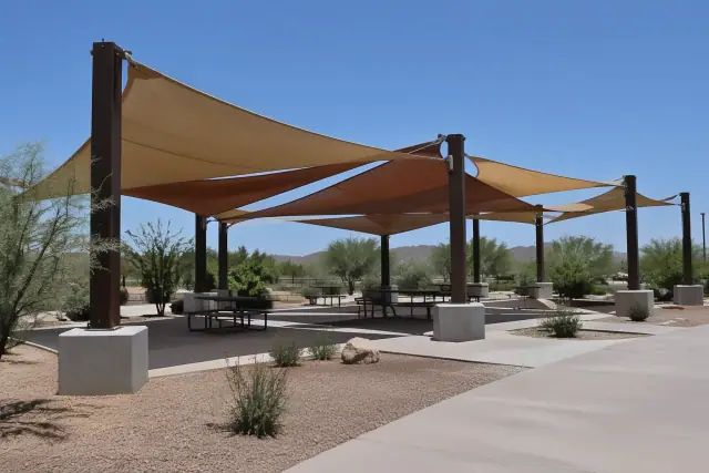 Tensioned membrane shade structure over a public seating pavilion in Apache Junction, AZ.