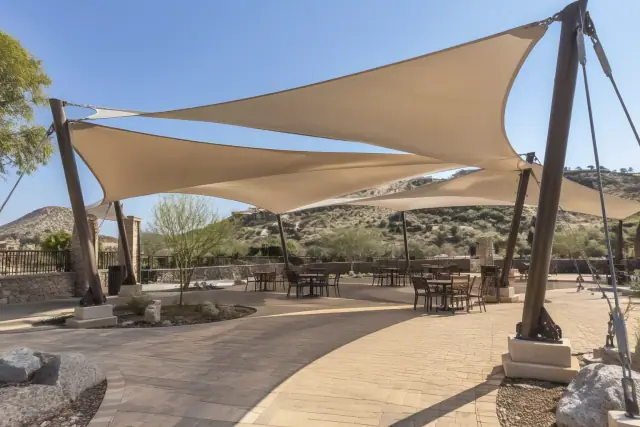 Tensioned membrane shade structure over an outdoor seating pavilion in Fountain Hills, AZ.