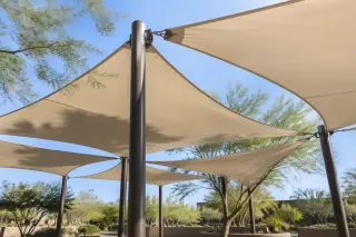 Tensioned membrane shade array and stamped concrete plaza in Gilbert, AZ.