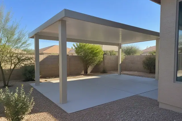 Insulated aluminum patio cover and ramada installed over a concrete slab in a residential backyard in Gilbert, AZ.