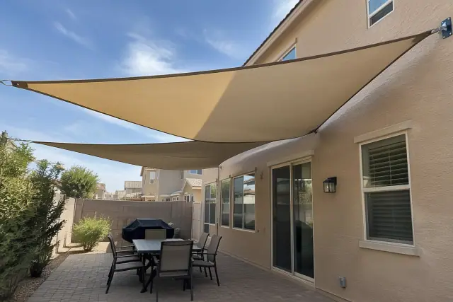 House-attached shade sails installed over a paver patio in Gilbert, AZ.