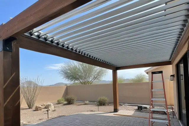 Louvered aluminum shade roof installation on a timber patio in San Tan Valley, AZ.