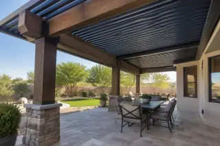 Adjustable aluminum blade system mounted on timber beams over a stone patio in Gilbert, AZ.
