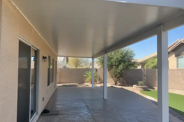 Solid insulated patio cover roof panel and aluminum post installation on a concrete slab in Gilbert, AZ.