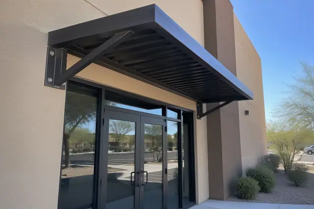 Metal awning installation above a commercial storefront in Gilbert, AZ.