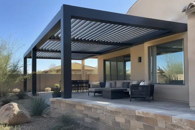 Motorized louvered pergola with adjustable aluminum blades over a Gilbert, AZ patio.