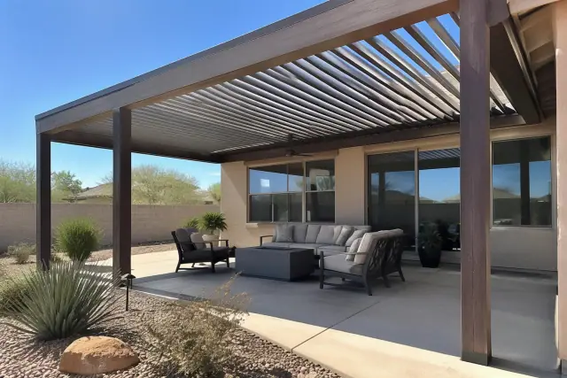 Motorized louvered roof installed on timber beams in a Gilbert, AZ residential backyard with desert landscaping.