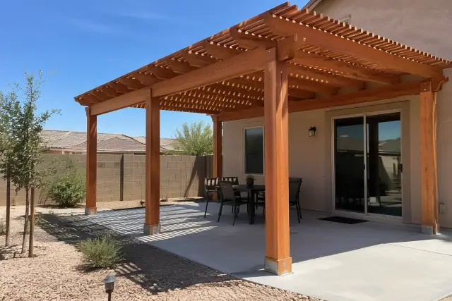 Open-lattice wood pergola with natural cedar rafters over a concrete slab in a Gilbert, AZ backyard.