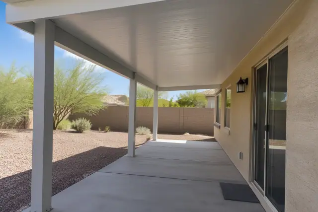 Patio cover installation with an insulated roof and aluminum posts in a Tempe, AZ backyard.