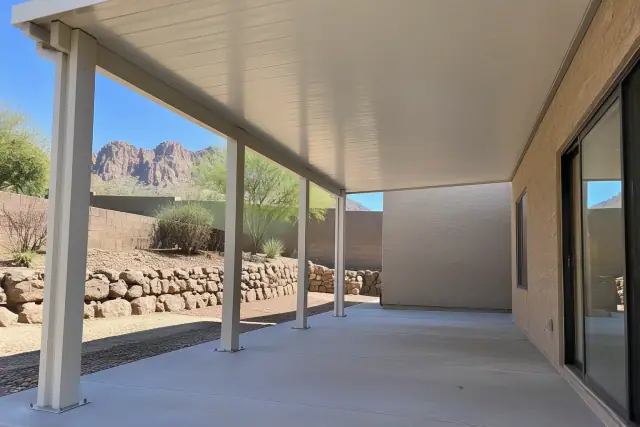 Patio cover installation with aluminum posts on a concrete slab in Apache Junction, AZ.