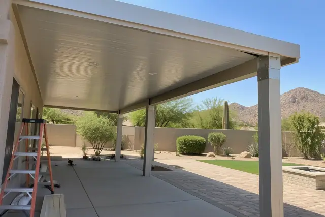 Patio cover installation in Paradise Valley, AZ, showing insulated roof panels and aluminum posts.