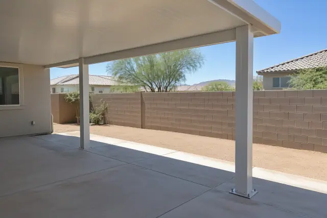 Patio cover installation with solid insulated roof panels on aluminum posts in San Tan Valley, AZ.