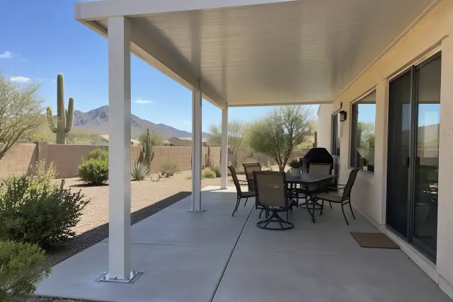 Patio cover installation with solid insulated roof panels on aluminum posts in Fountain Hills, AZ.