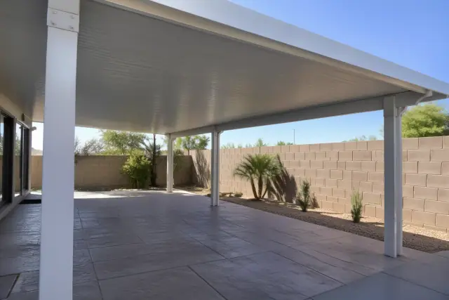Completed patio cover installation with aluminum connections in Gilbert, AZ.