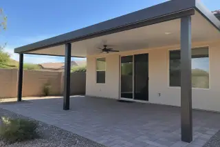 Finished patio cover installation with aluminum posts over a paver patio in Gilbert, AZ.
