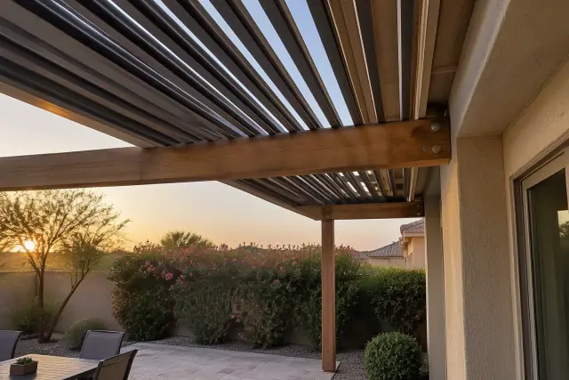 Pergola beam attached to house roof framing on a backyard patio in Gilbert, AZ.