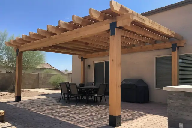 Freestanding wood rafter pergola installed over a backyard paver deck in Phoenix, AZ.