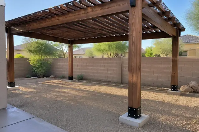 Heavy timber carport ramada posts anchored to concrete footings in a residential backyard in Gilbert, AZ.