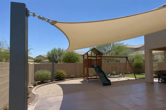 Cantilever shade structure with fabric canopy and tension cable in a Gilbert, AZ backyard.