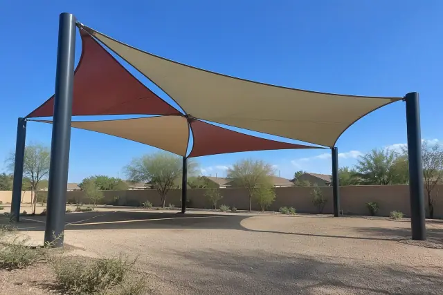 Multi-sail curved hip canopy installed over steel columns in Chandler, AZ.