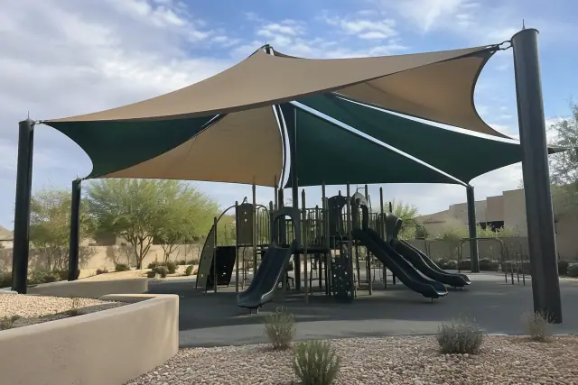 Multi-sail curved hip canopy installed over a playground in Scottsdale, AZ.