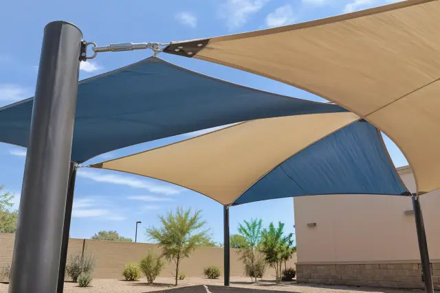 Playground shade structure with a high-tension fabric sail and steel column in Phoenix, AZ.