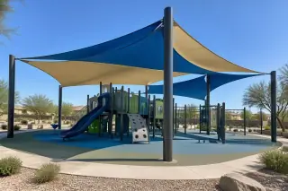Multi-sail curved hip canopy over a modern children's playground in Gilbert, AZ.