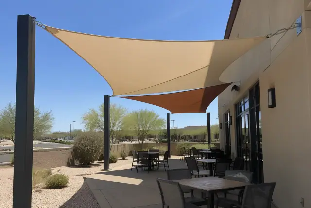 Shade sail installation over a restaurant patio at a commercial property in Gilbert, AZ.