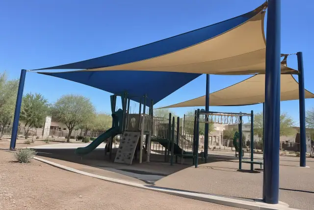 School playground canopies with tensioned fabric sails on steel columns in Gilbert, AZ.