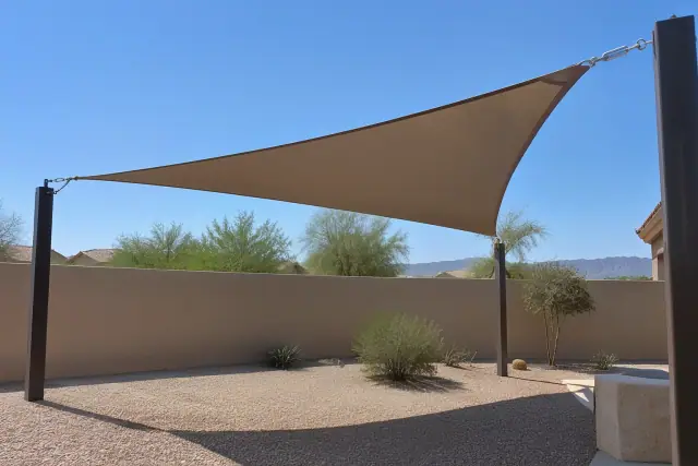 Shade sail installation in San Tan Valley, AZ, showing tensioned fabric attached to steel posts.