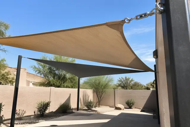 Shade sail installation with tensioned fabric and steel posts in Phoenix, AZ.