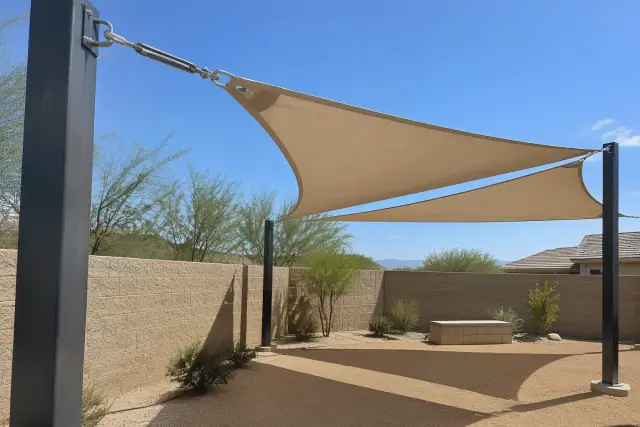 Shade sail installation over an open courtyard with steel corner posts in Queen Creek, AZ.