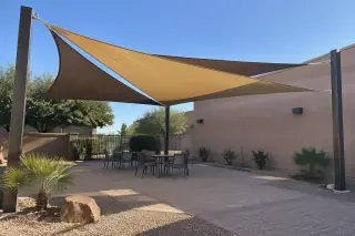 Shade sail installation with tensioned fabric membranes over a courtyard in Gilbert, AZ.