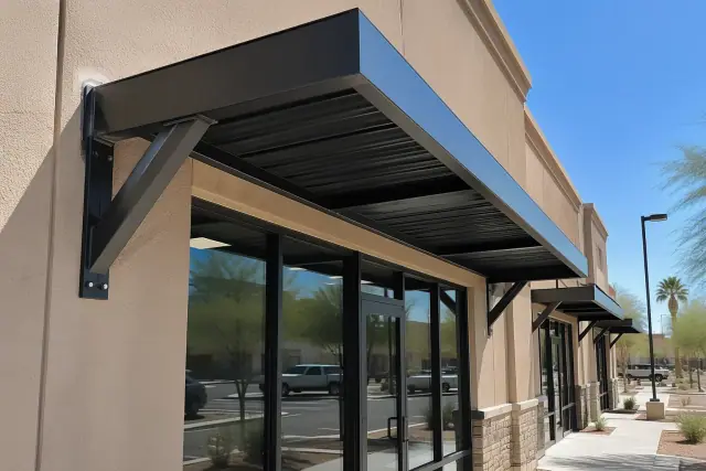 Commercial metal awning installation on a stucco storefront in Gilbert, AZ.