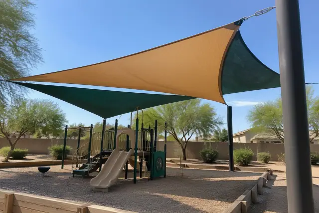 Tensioned fabric shade sails over a playground with desert gravel groundcover in Gilbert, AZ.