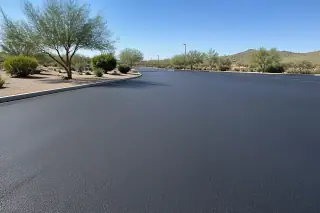Smooth black asphalt surface with uniform texture and desert landscaping in Goodyear, AZ.