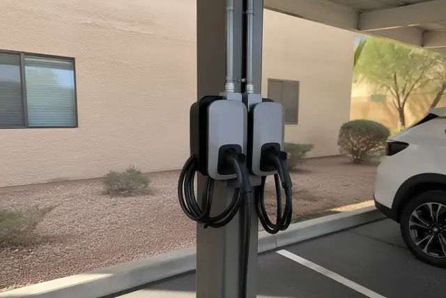 Dual-port EV charger installed on a steel post at an apartment complex in Mesa, AZ.