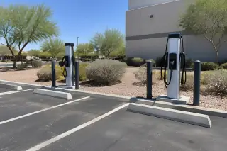 Dual pedestal EV charging stations in a paved employee parking lot in Mesa, AZ.
