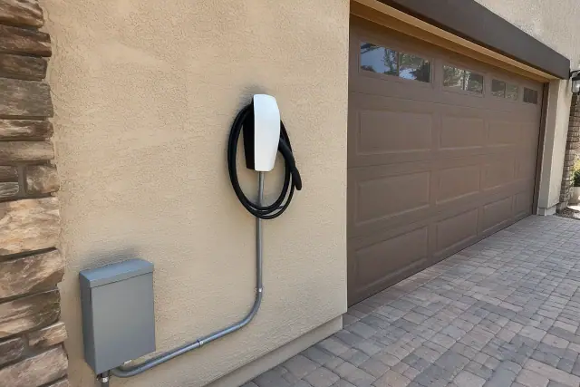 Newly installed EV charger panel on a stucco wall in Mesa, AZ.