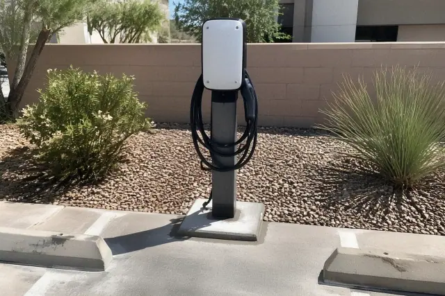 EV charger repair and replacement in Mesa, AZ, showing fresh mounting grout and an unpowered faceplate.
